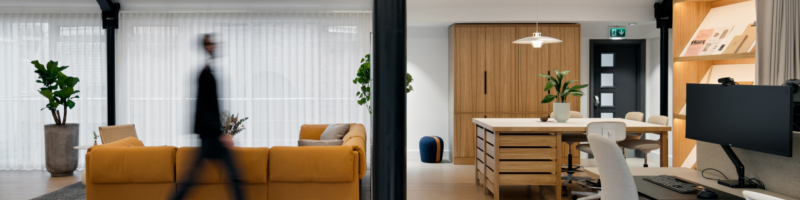 A blurred man walking in a room