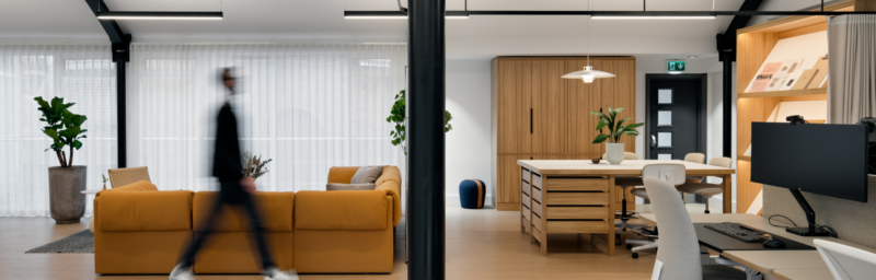 A blurred man walking in a room